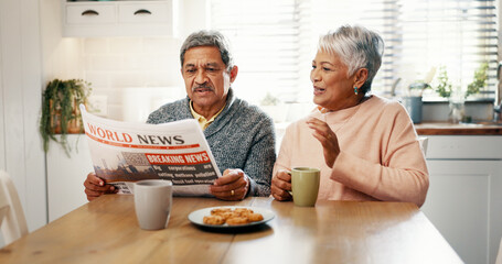 Senior couple, newspaper and coffee in kitchen, discussion and breakfast with headline, update and story. Elderly man, woman and talk with tea cup, article or newsletter with bonding in retirement