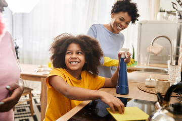 Loving LGBT family shares laughter and chores in the kitchen with their daughter