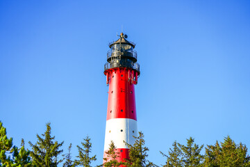 View of the red and white Hörnum lighthouse in the south of the island of Sylt.
