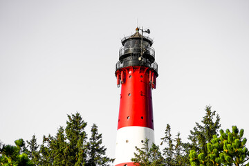 View of the red and white H&ouml;rnum lighthouse in the south of the island of Sylt.
