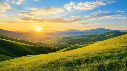 Naklejka premium Golden morning sun rising over vast rolling hills casting long shadows across green meadows and valleys. Concept of hope, peace, nature and fresh beginning.