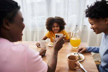 Joyful family breakfast time sharing laughter and love in a cozy kitchen setting