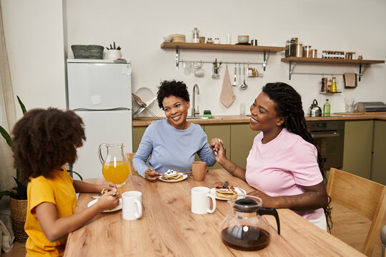 Family bonding over breakfast in a cozy kitchen filled with joy and laughter