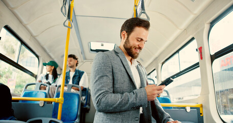 Business, man and journey on bus with phone for travel schedule, checking notifications and morning commute. Happy, passenger and smartphone on public transport for work destination and social media