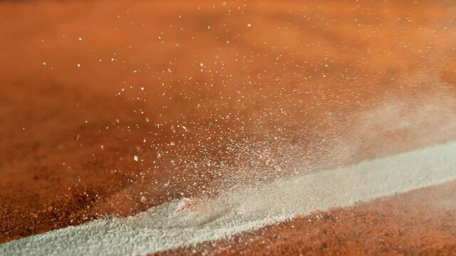 Super Slow Motion Detail Shot of Tennis Ball Hitting a Clay Court . Filmed on High Speed Cinematic Camera at 1000 fps