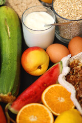 Various healthy fruits, vegetables and cereals on dark background. Selective focus.