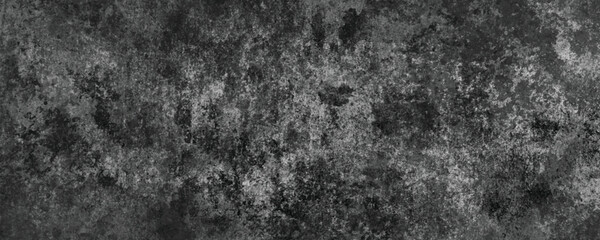 The Natural Erosion of a Dark and Scratched Cement Wall Creating an Abstract Pattern

