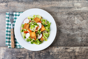 Fattoush salad, Traditional Lebanese Salad on wooden table. Top view. Copy space