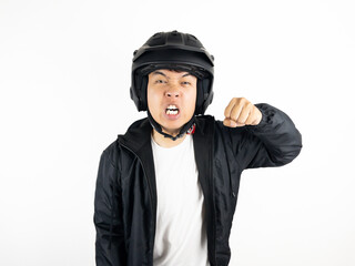 Asian man wearing motorcycle helmet with angry and upset expression on white background
