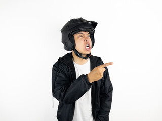 Asian man wearing motorcycle helmet with angry and upset expression on white background