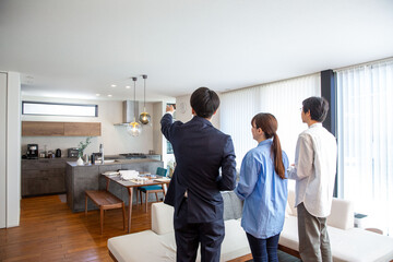 Housing sales: Salesman showing a model room, back view