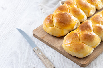 Traditional Easter braided bread. Tsoureki braid on white wooden table