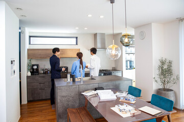 Housing sales: Salesman showing a model room, back view