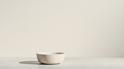Minimalist design showcases simple bowl against soft, neutral ba