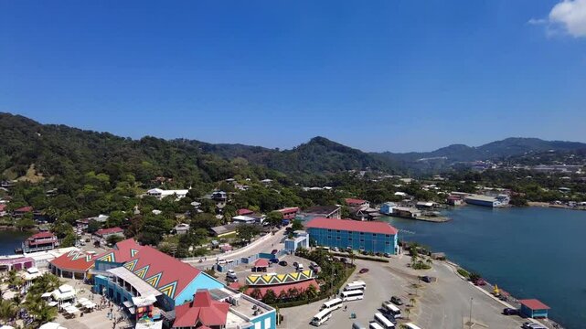 The port area in Roatan, Honduras with colorful buildings, sea and nature