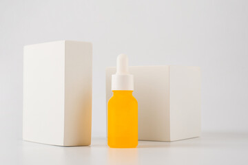 Plastic yellow tube for cream or lotion. Skin care or sunscreen cosmetic with stylish props on white background.