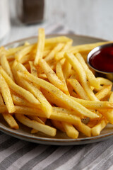 Homemade French Fries and Ketchup on a Plate, low angle view. Close-up.