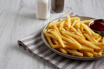 Homemade French Fries and Ketchup on a Plate, side view.