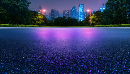 Empty asphalt road at night, city skyline in background