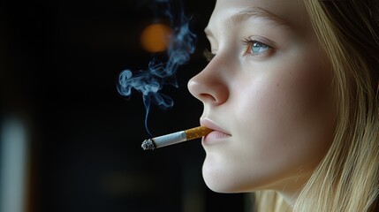 Obraz premium Low Key Portrait of a Young Woman Smoking a Cigarette, Contemplative and Addicted, Health Issues,