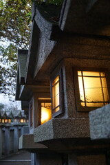 Many stone lanterns line the approach to a Japanese temple