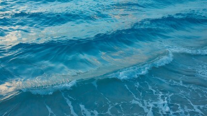 Turquoise ocean waves crashing on the shore.