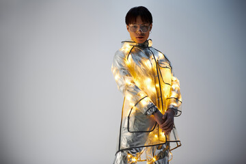 Stylish young Asian man showcases modern fashion with illuminated outfit