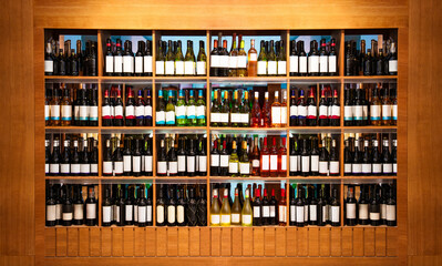 Front view retail display with wine bottles. Wine shop background.