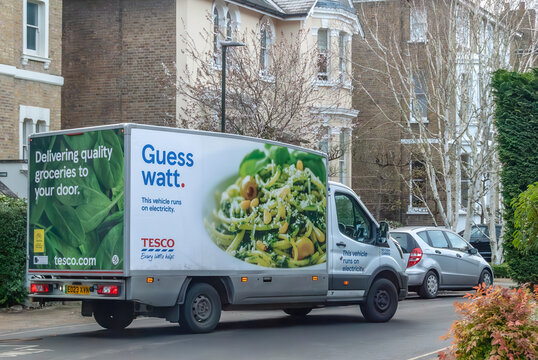Tesco electric delivery van, 'guess watt' van on the street in Richmond. London. Eco-friendly groceries delivery in London.