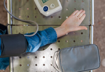
Young boy measuring blood pressure in a park. Concept of children’s health, early diagnosis, and...