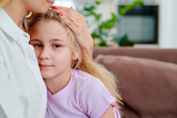 Mother comforting daughter at home with love and warmth  