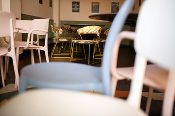 empty interior of cafe with colorful chairs and tables