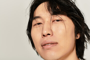 Handsome young Asian man showcasing modern style with expressive expression