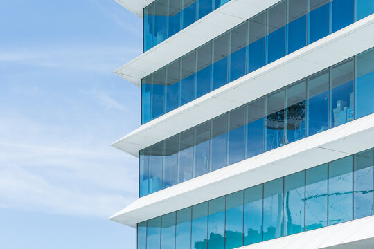 Pointed cement protrusions between glass windows of a modern high rise building