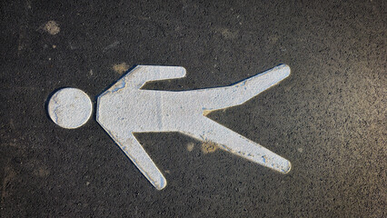 White stick figure on asphalt