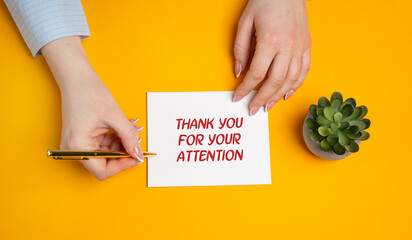 Thank you for your attention concept. Polite expression used to show gratitude to someone for listening, focusing, or paying attention to what has been said or presented. A woman writes notes
