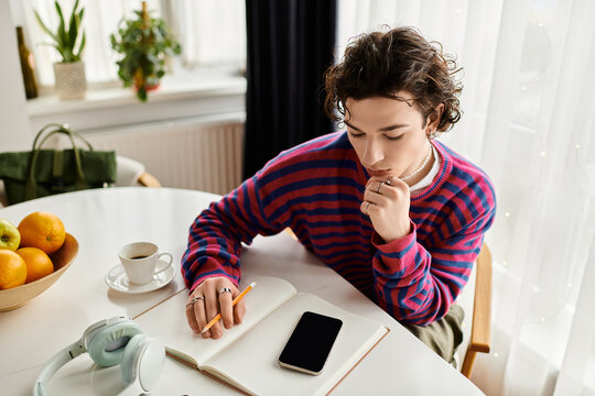 Curly non-binary student studying in a vibrant apartment filled with natural light