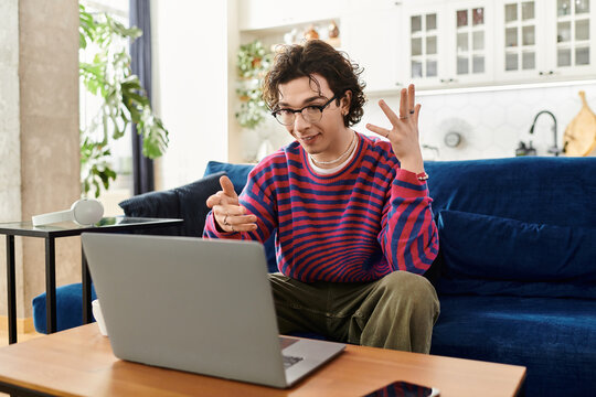 Vibrant conversation in a modern apartment with a young non-binary student