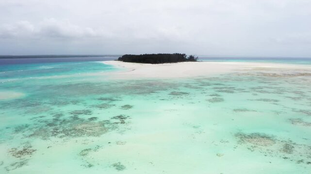 4K flying up drone footage above white sandbanks coast with beautiful transparent rippled waves washing coral reefs atoll near Mnemba Island, Tanzania. Traveling in innocent Nature concept.