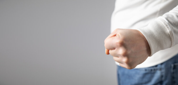 Caucasian angry and aggressive man threatening with fist.