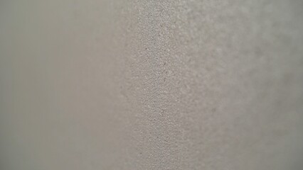 Close-up of textured gray wall showing rough surface