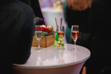 There is a table that features three glasses of wine resting on it