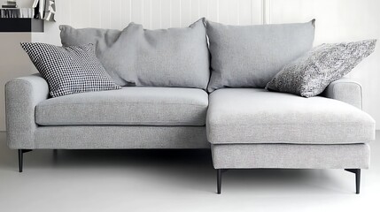A light grey modern sofa with comfortable decorative pillows
