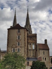 Fototapeta premium Gothic church in Moulins with dual spires under a cloudy sky