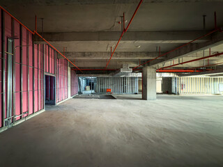 Empty Construction Site Interior with Framed Walls and Exposed Pipes