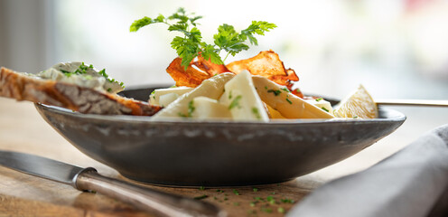 White asparagus with fresh ingredients in a dark ceramic bowl on rustic wood. Background for halthy...