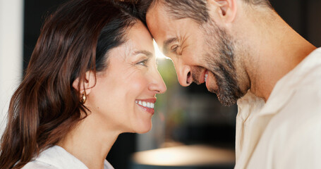 Naklejka premium Connection, happy and couple in home with care, bonding and forehead touch in morning for greeting. Love, romantic and man with woman for support, safety and commitment in marriage in house together.