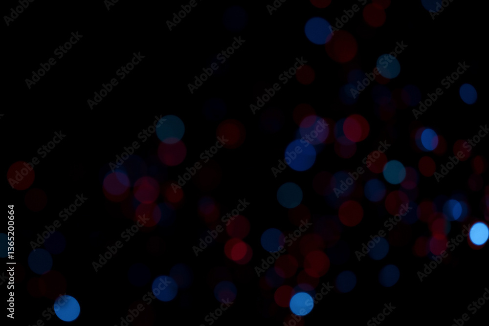 Aufkleber Blurred red and blue lights float against a stark black backdrop, creating an abstract bokeh effect. The defocused orbs of color provide a sense of depth and visual texture.