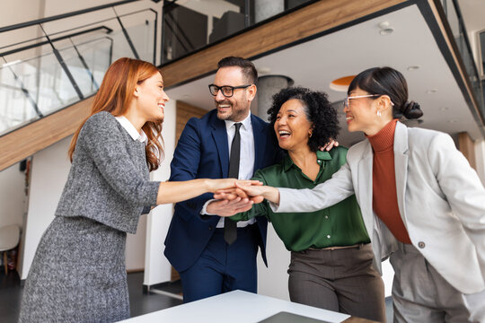 Diverse Business Team Celebrating Collaboration in a Modern Office Setting