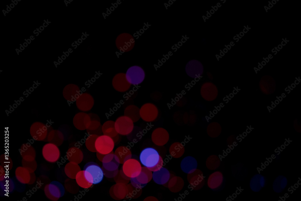 Fototapete blurred lights glow softly against the dark backdrop, creating a bokeh effect. red and blue orbs of 